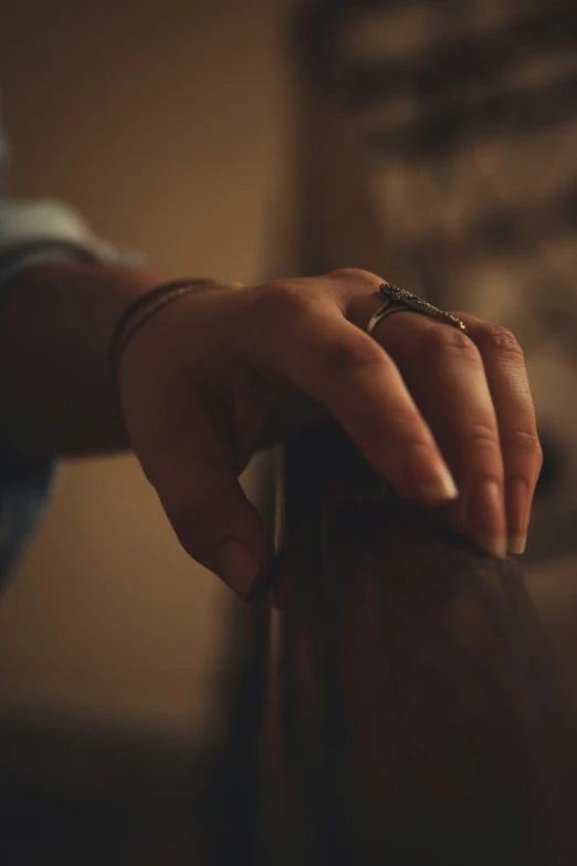 a womans hand is holding onto a wooden door