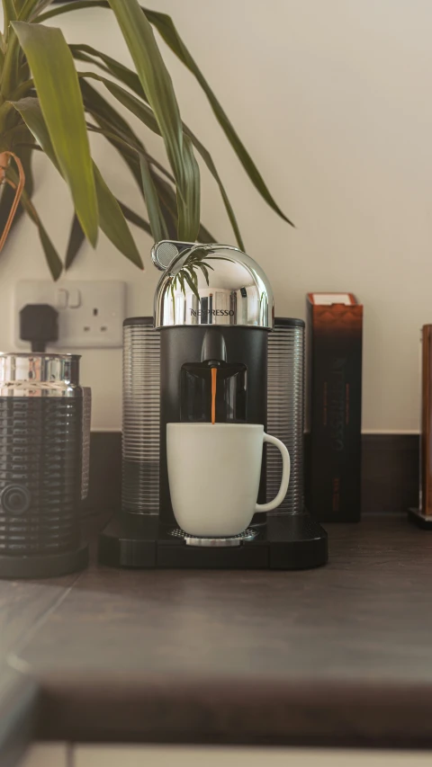 a mug of coffee sitting next to a toaster