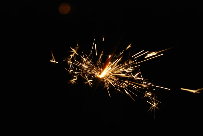 a sparkler with several lit up spots in the dark