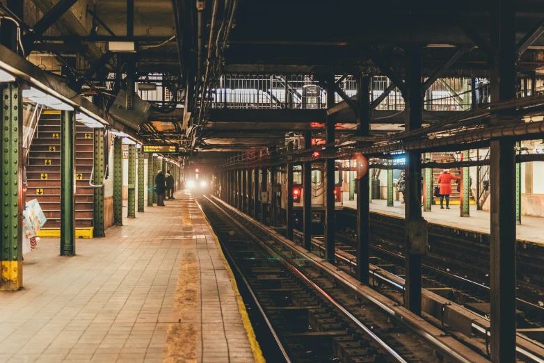 the lights shine down on an empty train platform