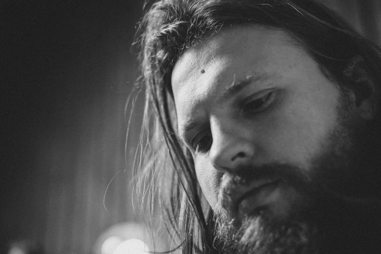 black and white image of bearded man with long hair