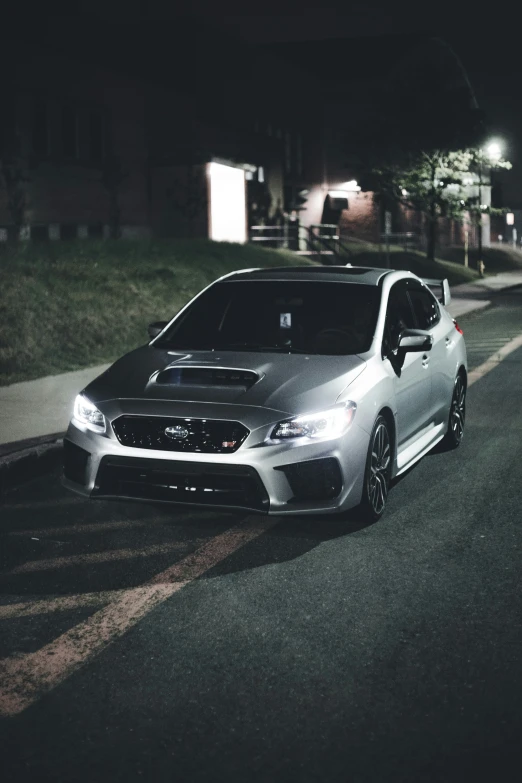 a subaru that is parked along the side of the road