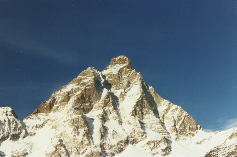 a large mountain with very big snow capped peaks