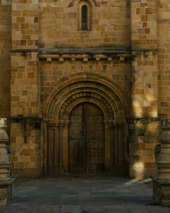 an old building with a large stone door and tall tower