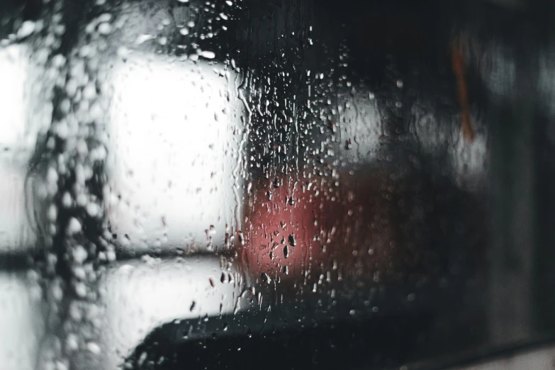 rain is falling on the window of a vehicle