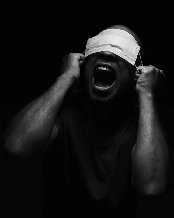 a man with his face taped off by a blindfold