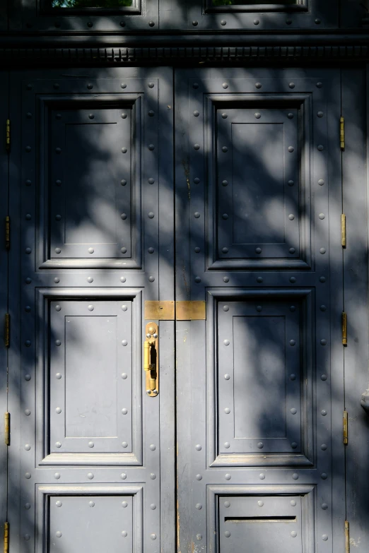 a blue front door with a gold handle on it