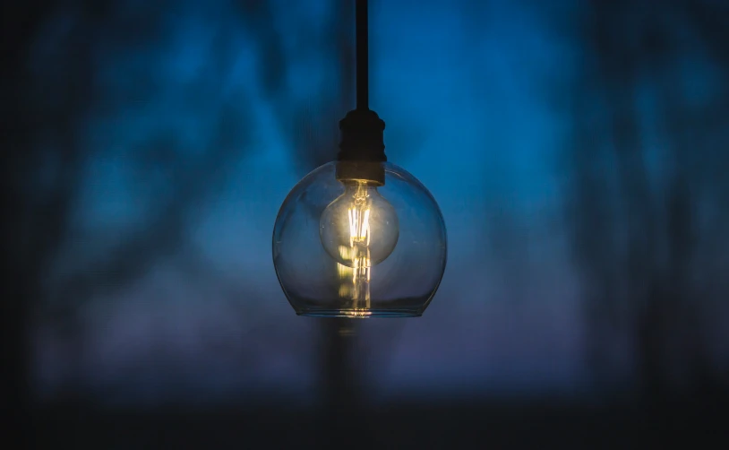 a single light bulb that has been blown into the dark