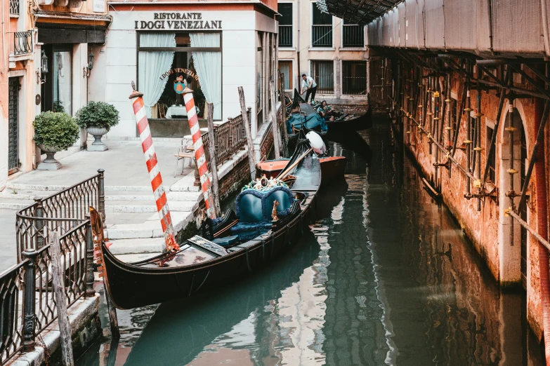 a canal is shown with boats passing by