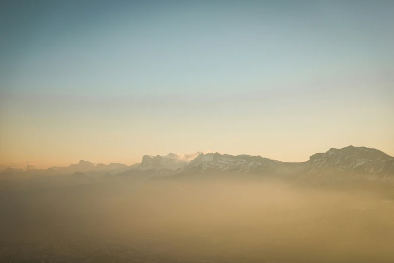 a scenic view of a mountain range covered in fog