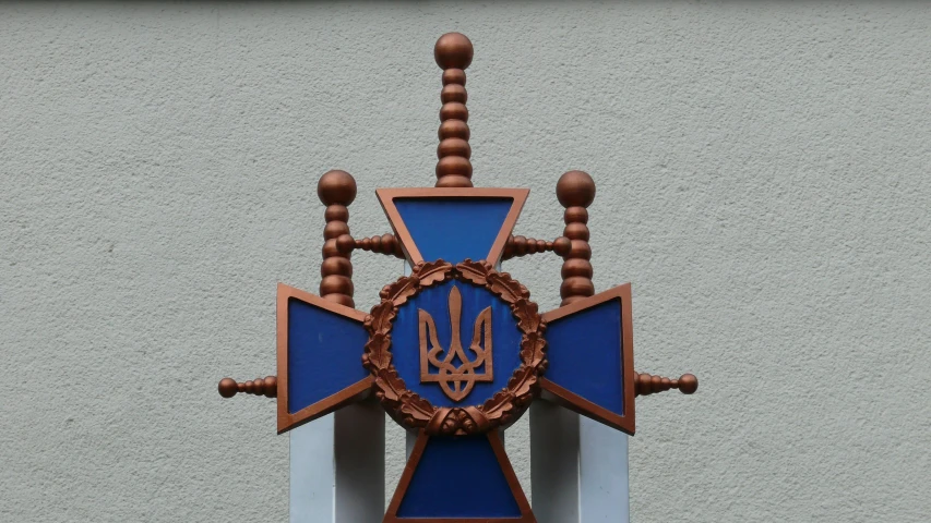 a brown and blue clock is on the side of a building