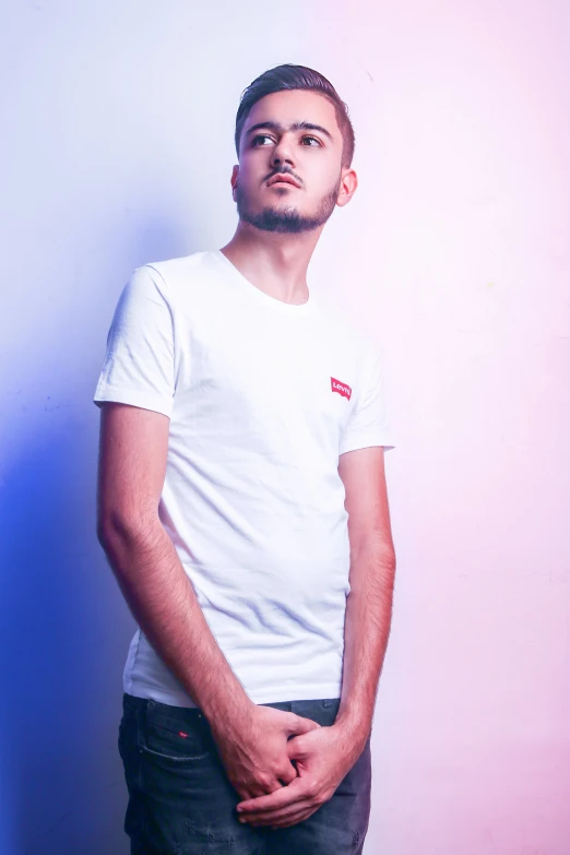 a young man in white is staring at the sky