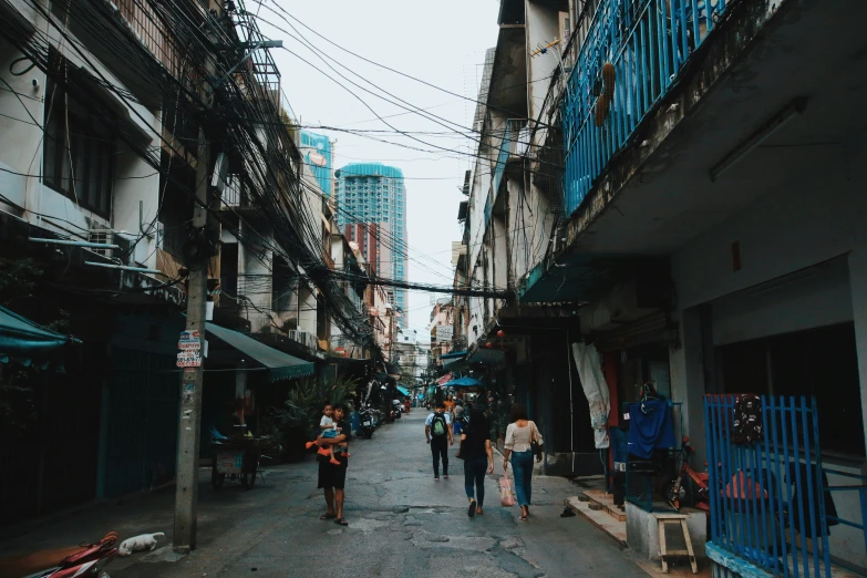 the people are walking down the narrow alleyway