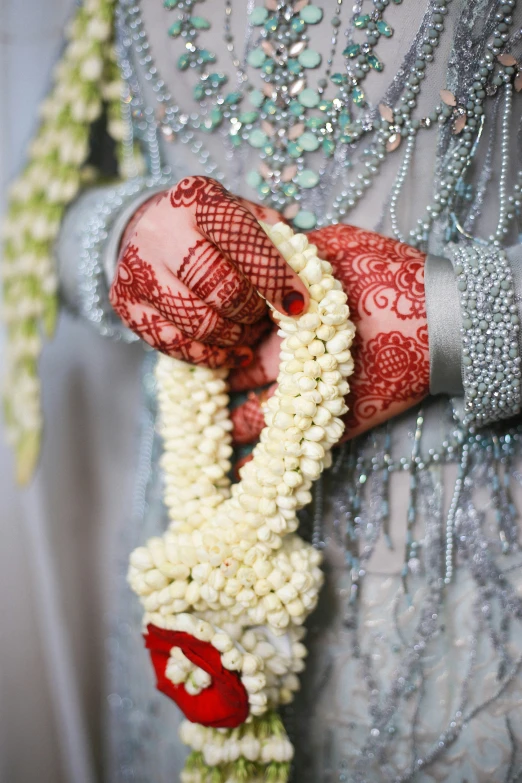 a woman is holding her jewelry as she stands