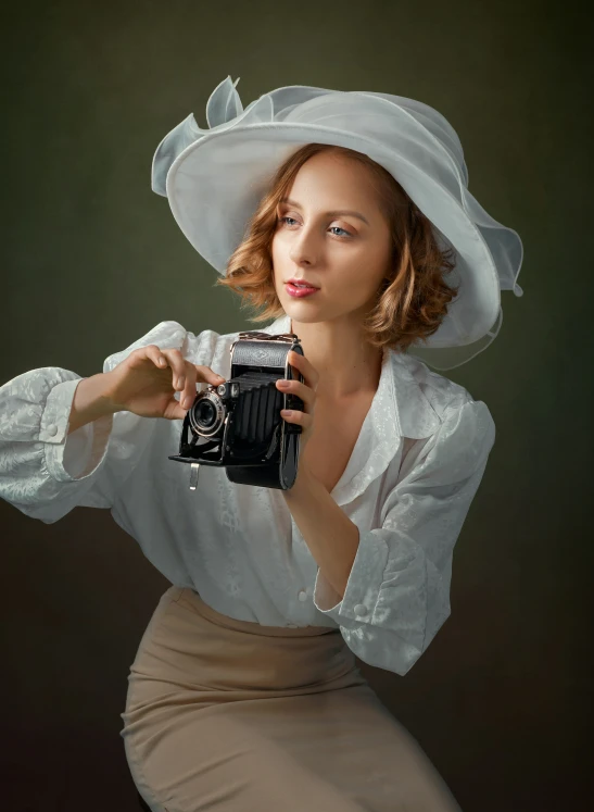 a woman is dressed in white holding an old fashioned camera