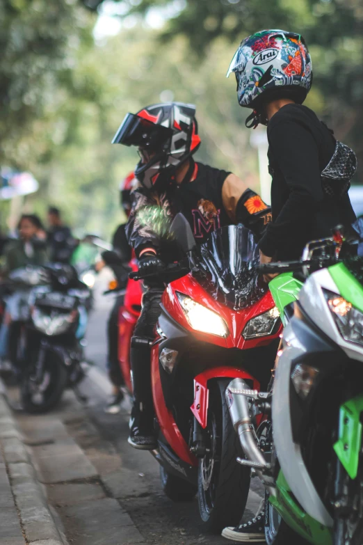 people riding motorcycles on street next to buildings