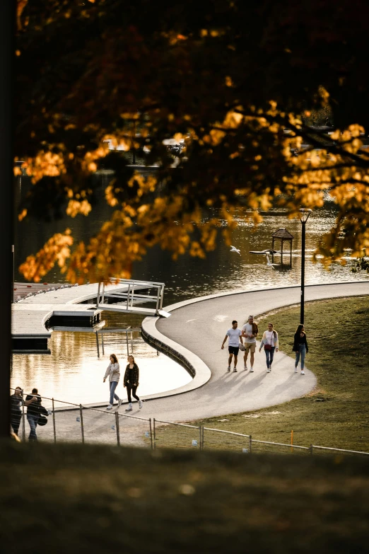 people walking along the edge of a waterway