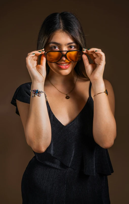 a woman wearing glasses with a necklace on her arm