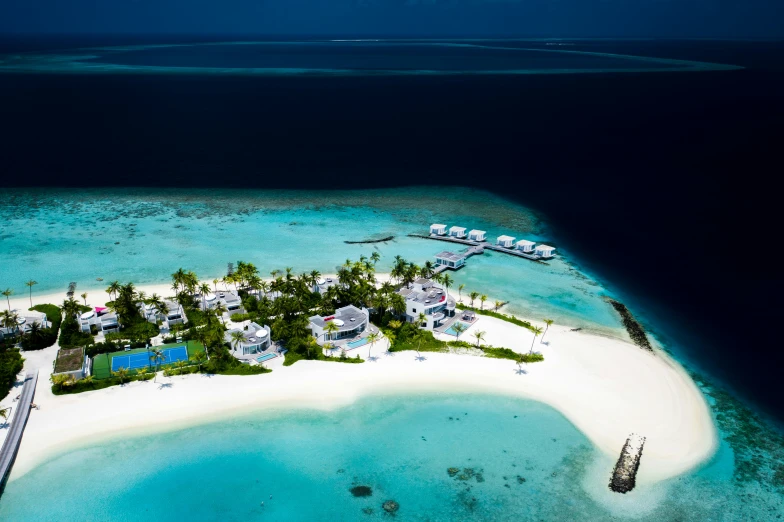 a tropical island and small white house surrounded by water