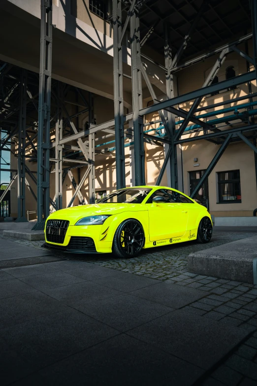 an image of a yellow car parked under an overpass