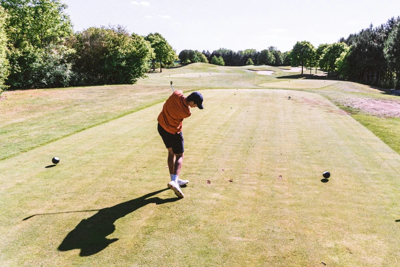 a person on a golf course about to hit the ball