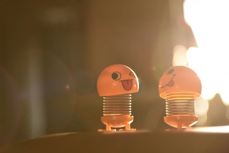 two wooden light bulbs are shown in front of a window