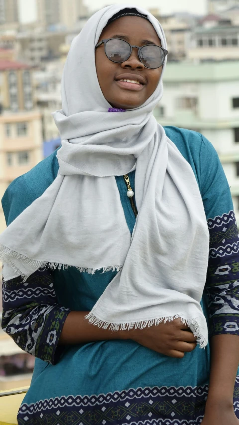 a person wearing glasses and a head scarf