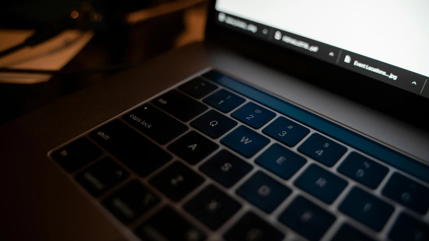 a black laptop with a gray keyboard is sitting in front of the computer monitor