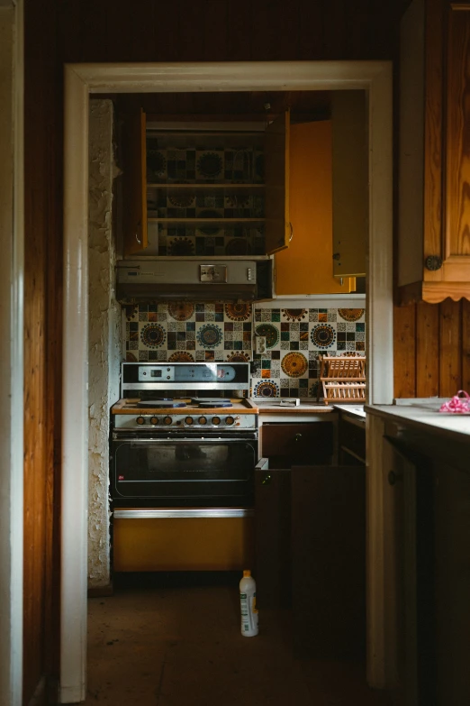 a dark kitchen with brown cabinets and white counters