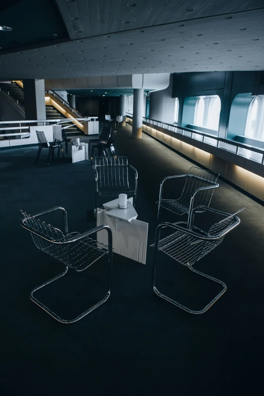 an empty office with modern chairs and lighting