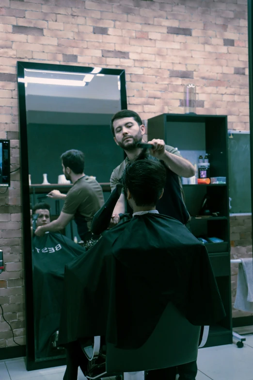 a man getting a haircut at a barber shop