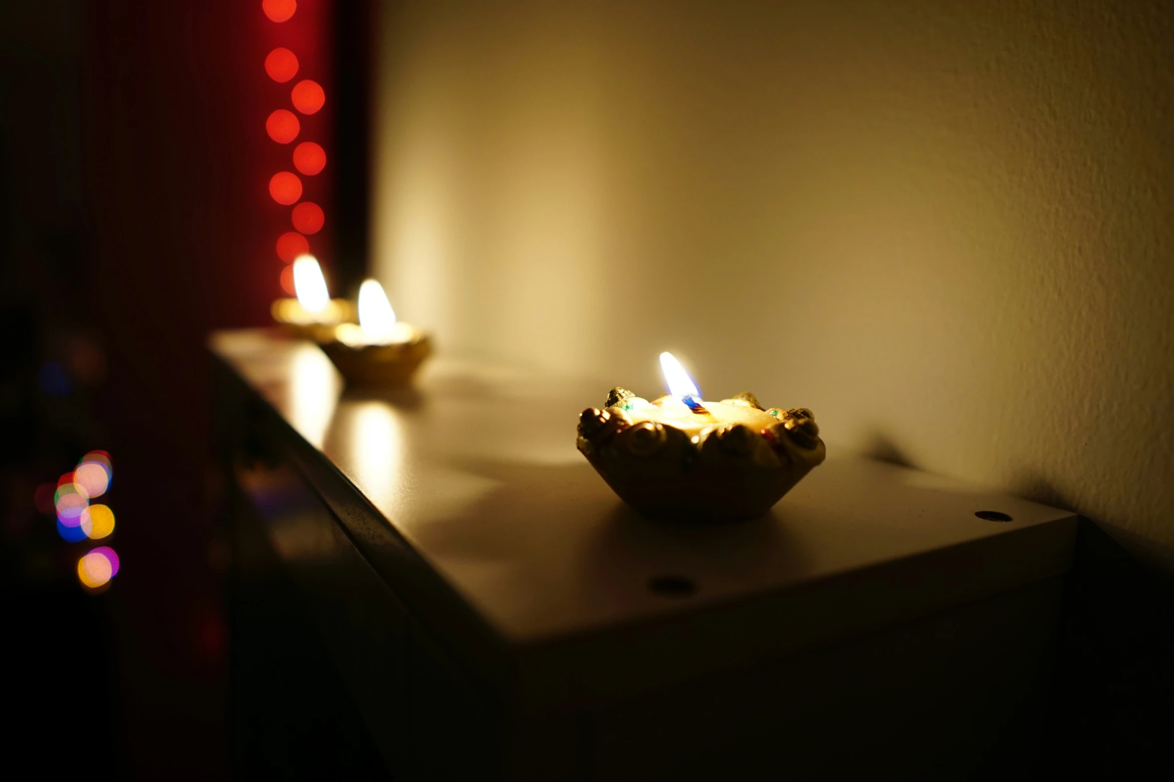 the three candles are sitting on the shelf