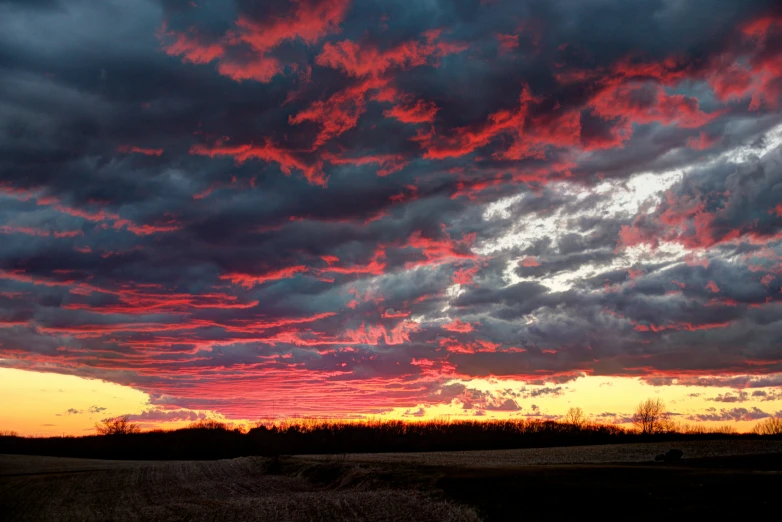 some clouds are seen at sunset over the plains