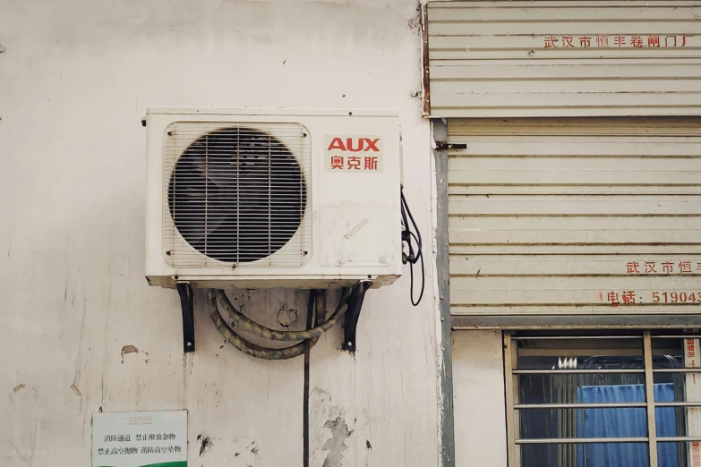 a air conditioner attached to a white building