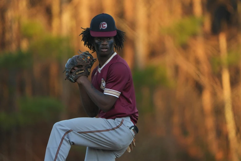 a man in a baseball uniform holding a ball