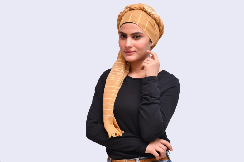 a woman with a head scarf is posing for the camera