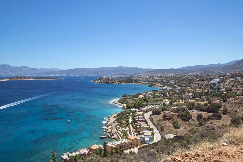 a body of water with a boat on it and buildings along the shoreline