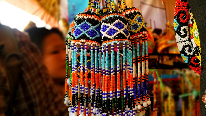 a hand holding some beads hanging from a pole