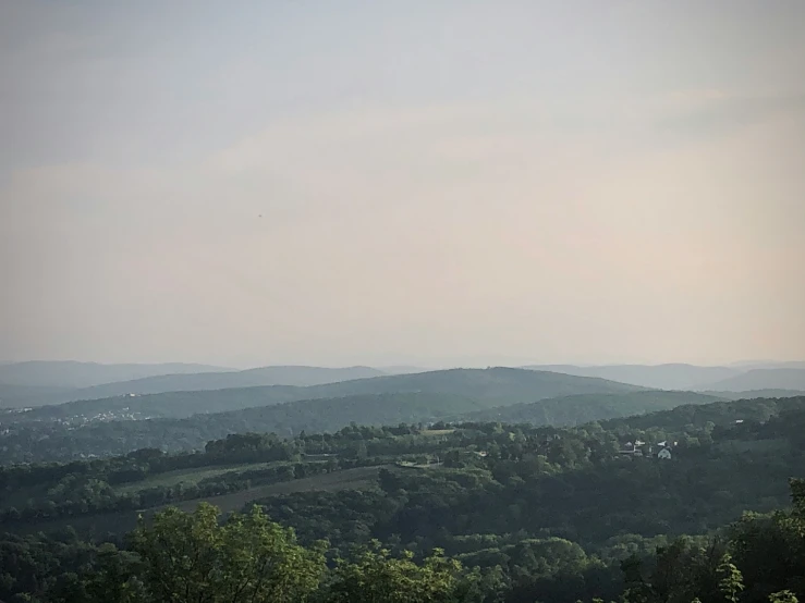 a view of a mountain from a hill near the woods