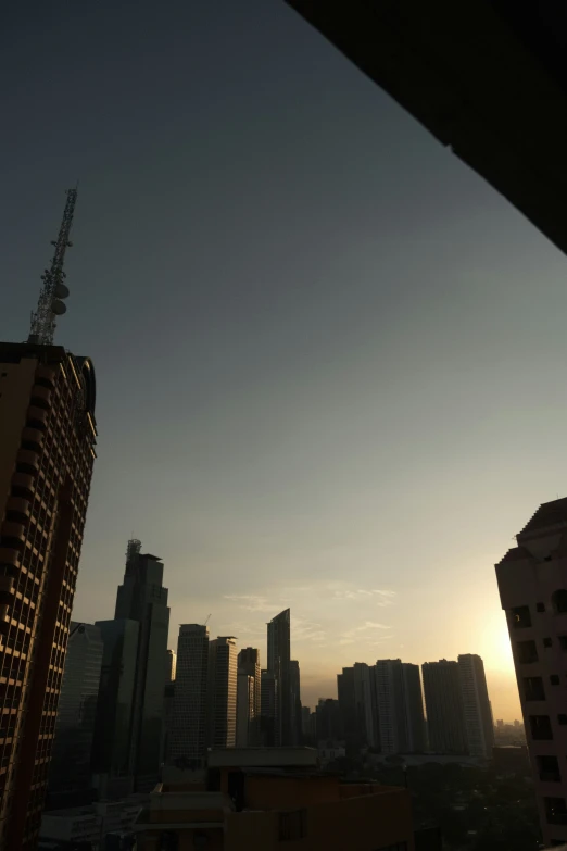 the city skyline at dusk taken from the back deck of a bus