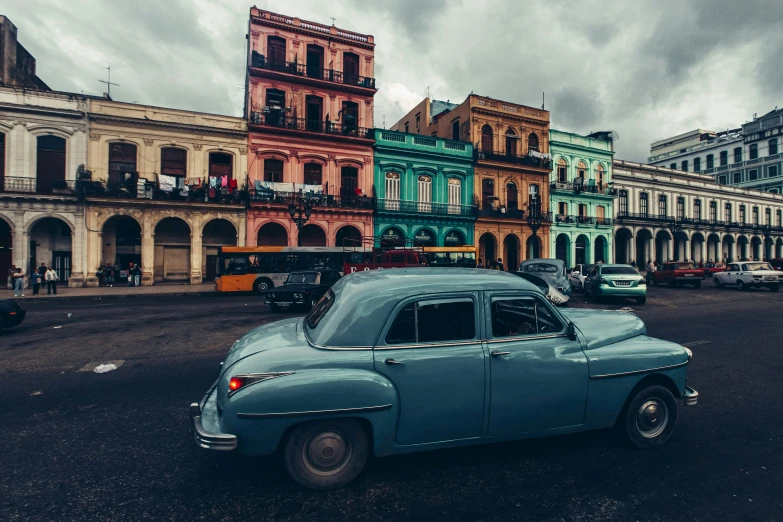 old cars and colorful building in an older style town