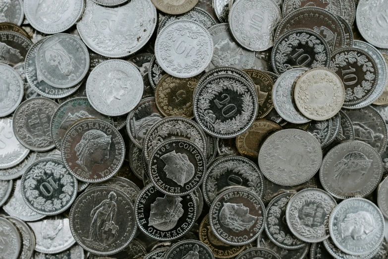 the piles of different british coins are all piled together