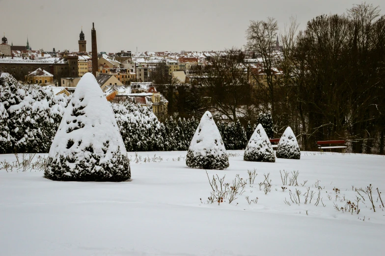 a view of a snowy city, with tall buildings