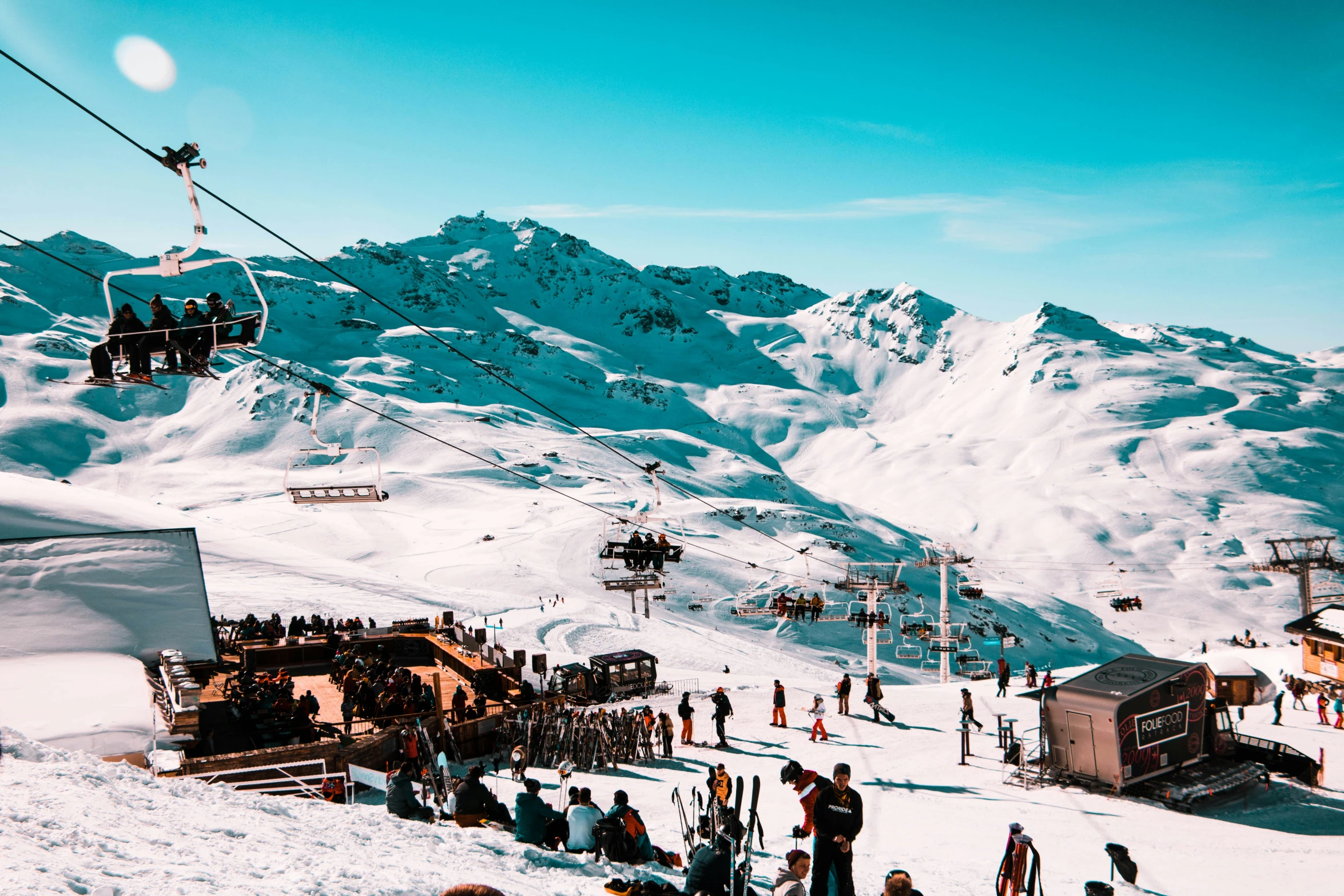 a bunch of people standing and skiing on snow covered ground