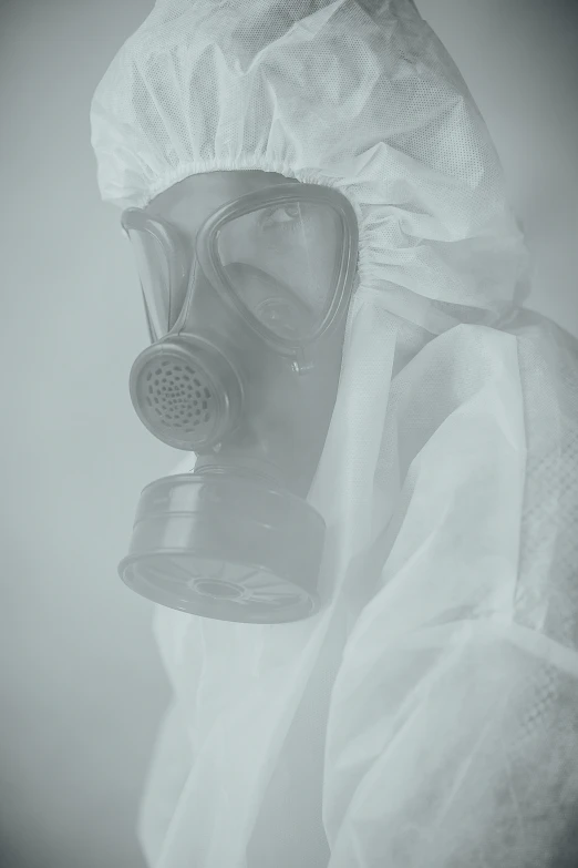 a white protective suit and a gas mask