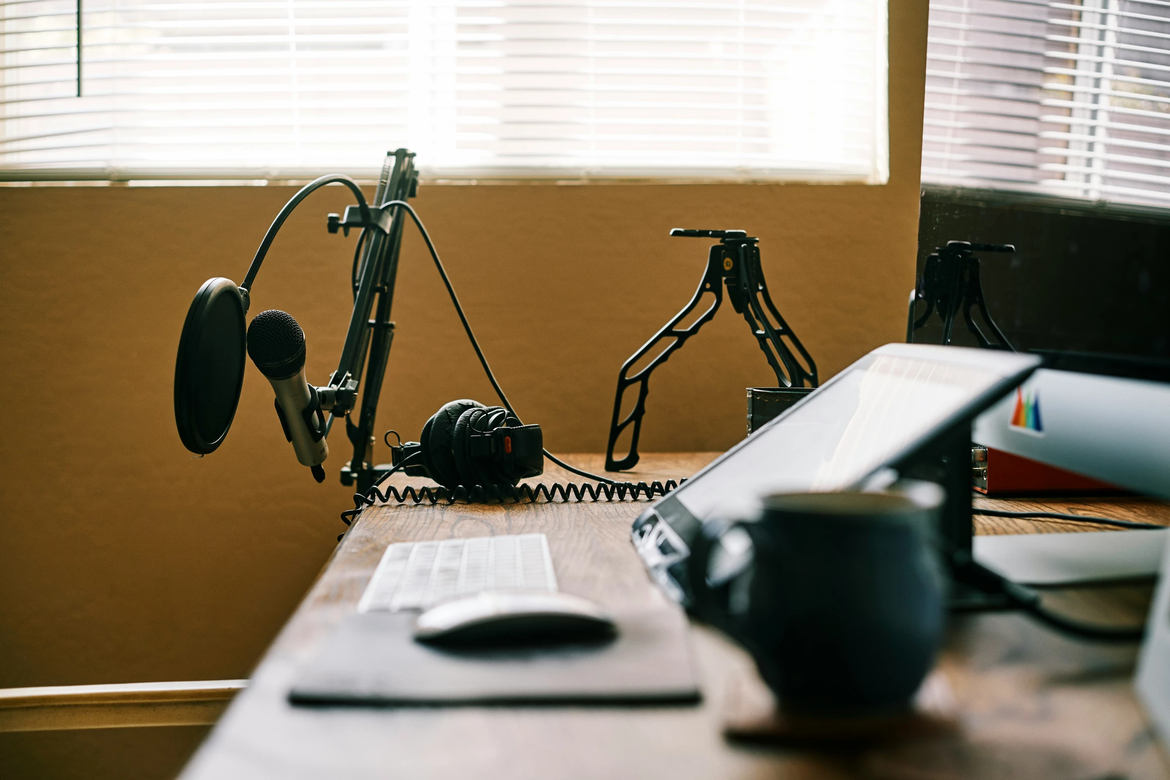 a work desk with office equipment and two computers