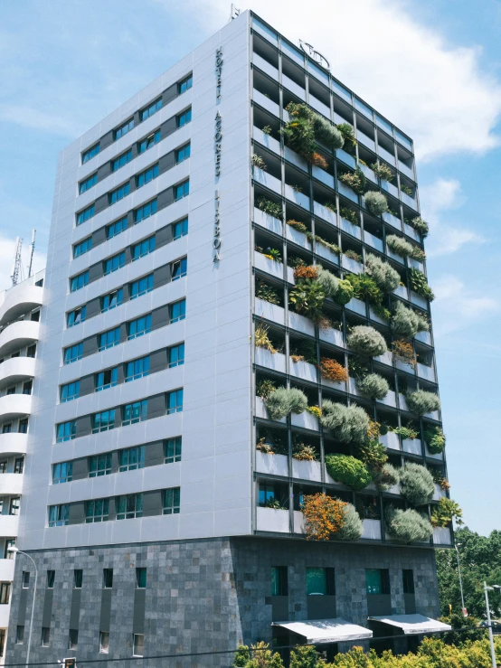 an outside view of a building with a wall of plants