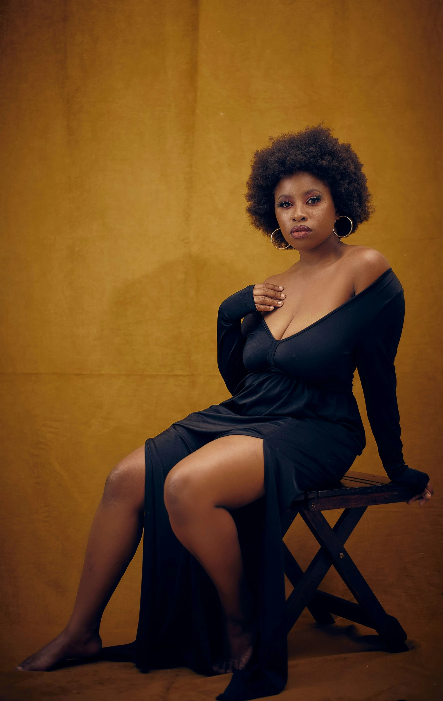 a woman sitting on top of a wooden chair