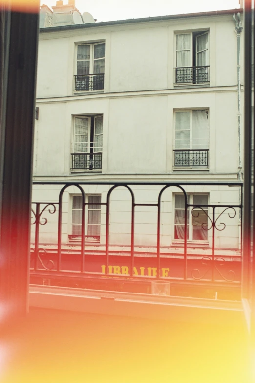 a train on the train tracks passing by a building