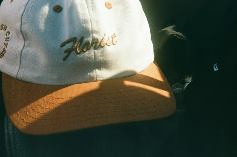 a white cap sitting on top of a person's hat